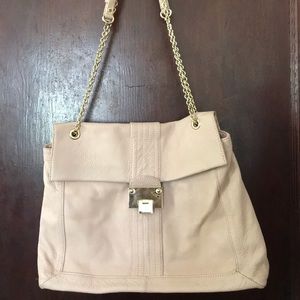 Pink bag with gold chains and lock